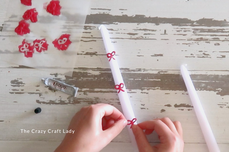 glue red bows to taper candles