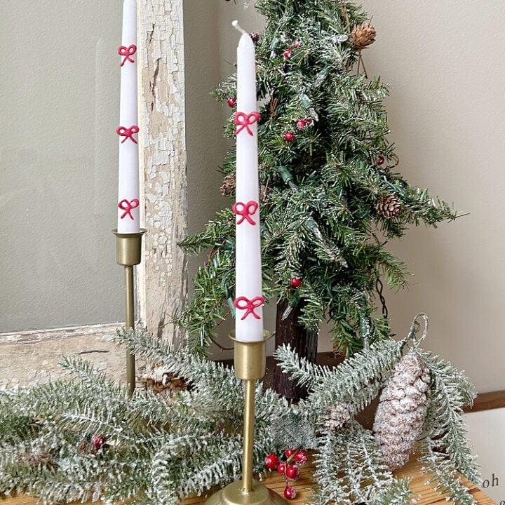 white taper candles with red bow detail