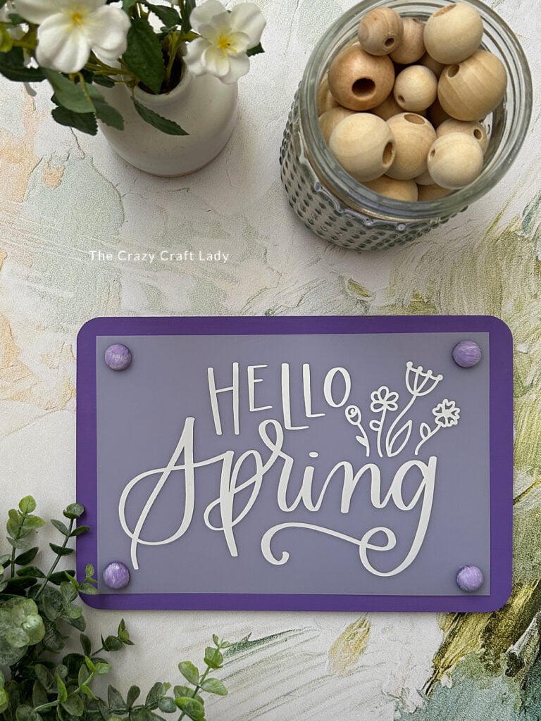 purple and white hello spring sign