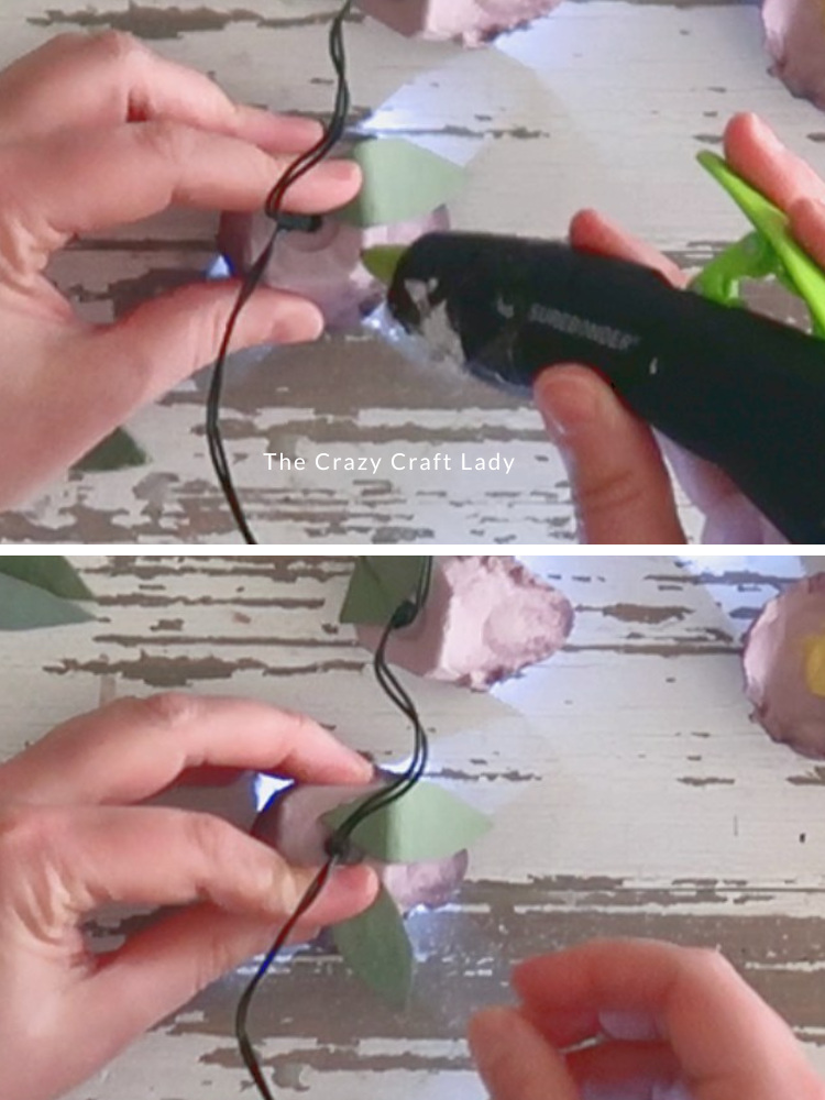 hot glue leaves to the flowers