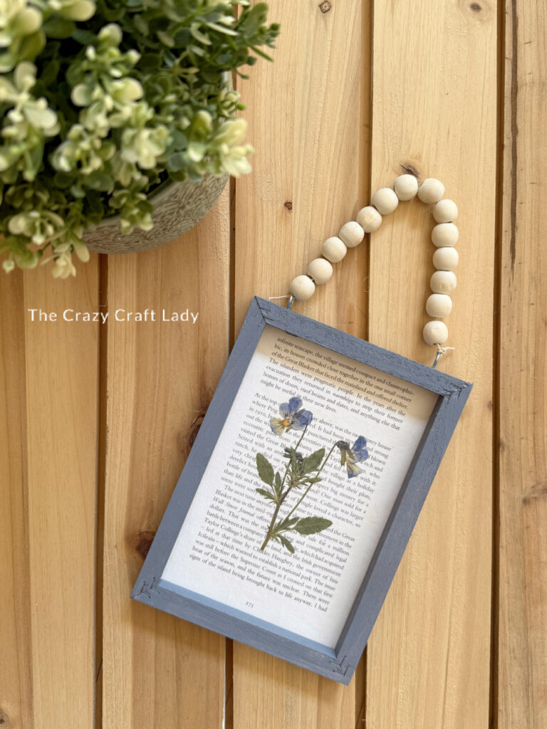 Pressed Flower on a Book Page in a Blue Frame with Wood Bead Hanger