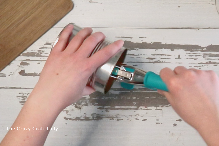 punch two holes in tin can