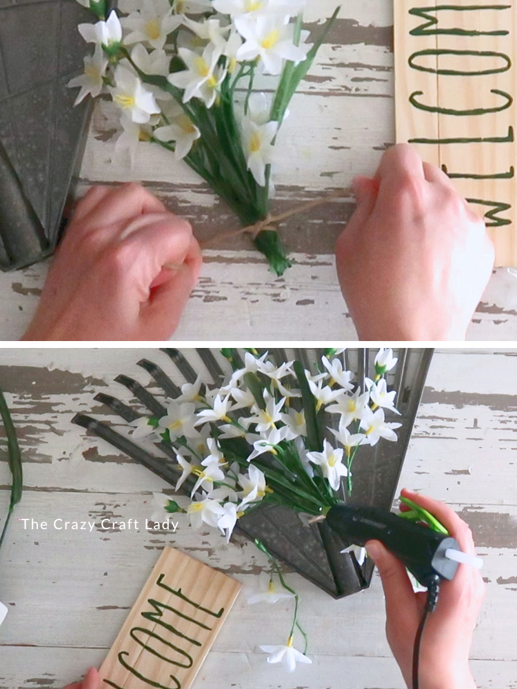 tie bundle of flowers and glue to rake