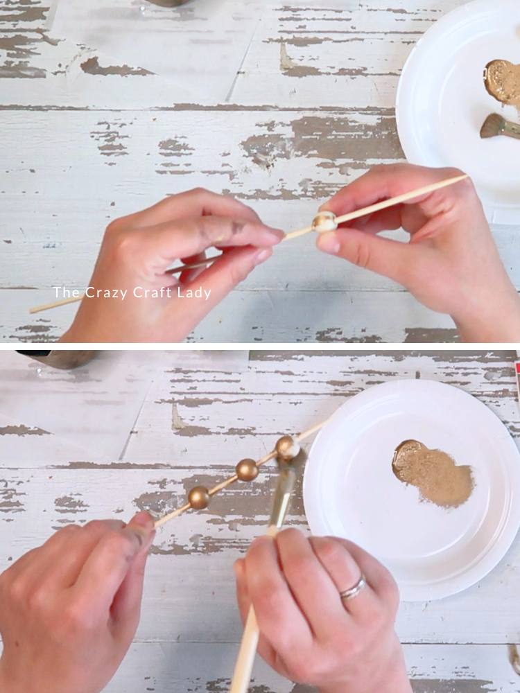 add wood beads to skewer and paint gold