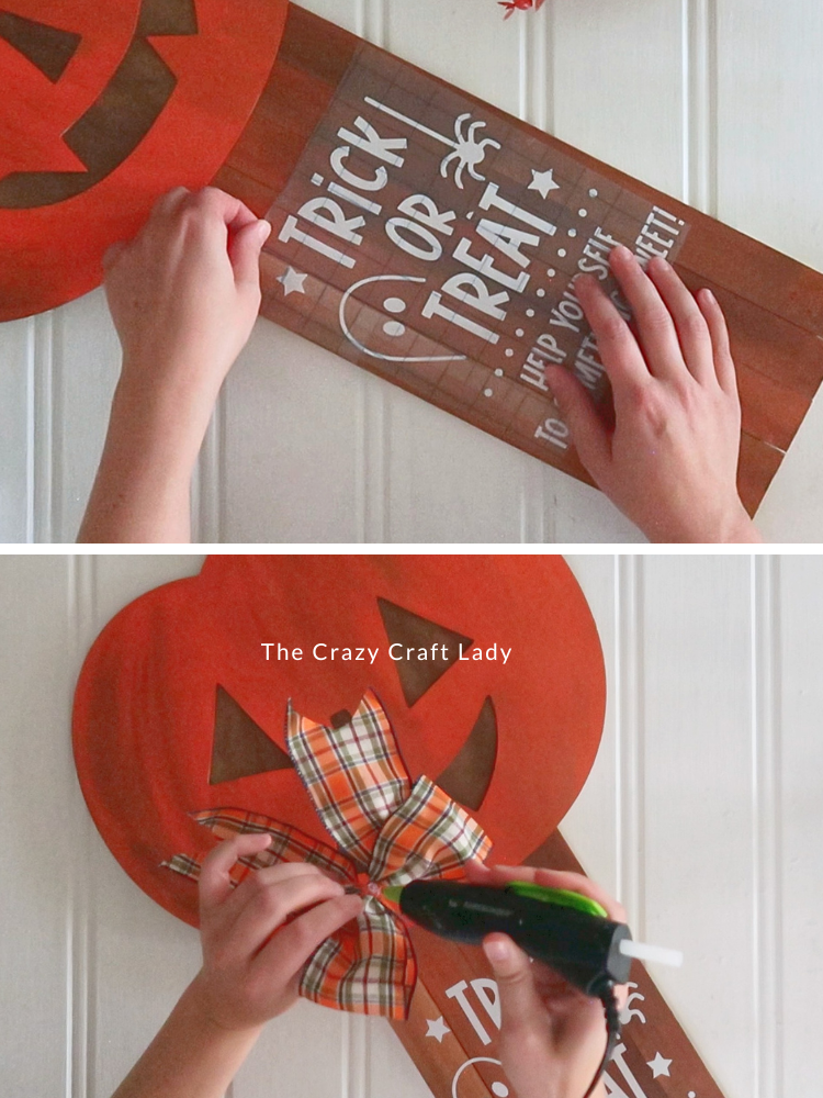 embellish the Halloween sign with white vinyl and a bow