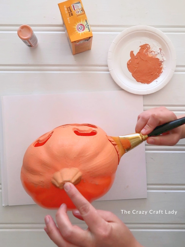 add a coat of orange paint mixed with baking soda to the orange jack o lantern