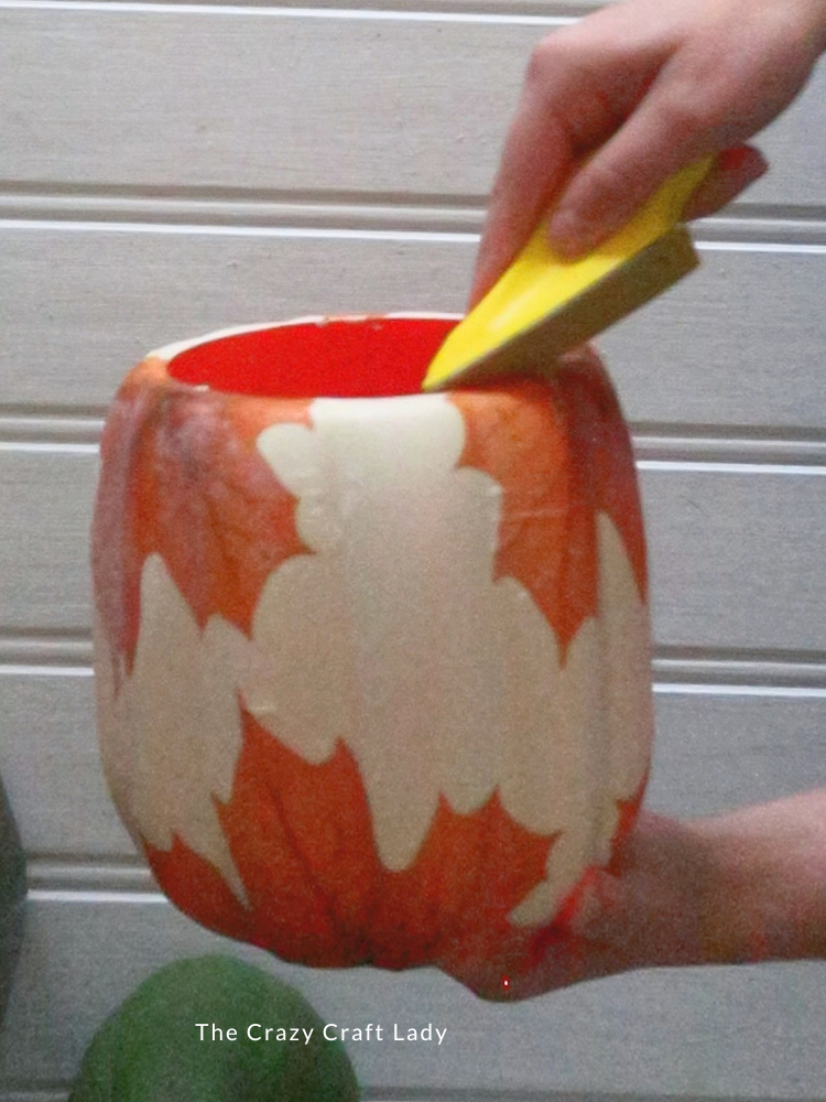 sand away excess paper napkin from bottom of plastic pumpkin